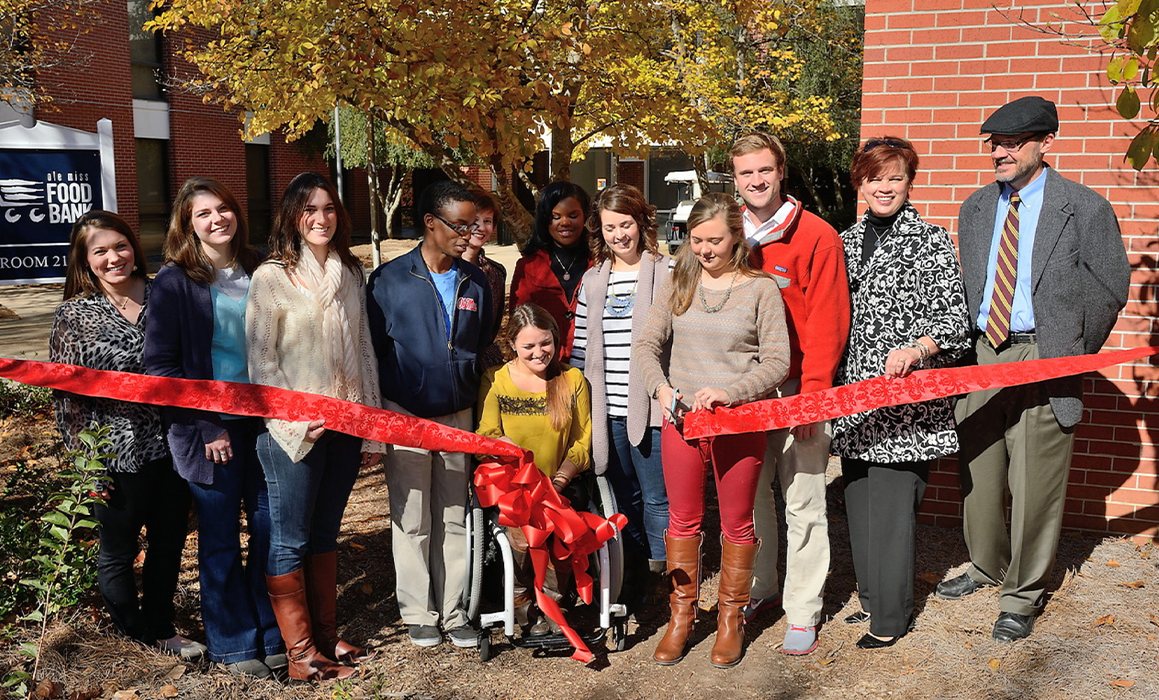 Diverse group; Ribbon cutting event for the UM Food Bank